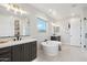 Spacious main bathroom featuring a soaking tub, double vanity, and bright natural light, offering a spa-like experience at 26388 N 77Th Dr, Peoria, AZ 85383