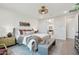 Serene main bedroom showcasing stylish decor and seamless access to the luxurious ensuite bathroom at 26388 N 77Th Dr, Peoria, AZ 85383