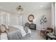 Stylish main bedroom with chic decor, including a designer mirror and a cozy seating area for added comfort at 26388 N 77Th Dr, Peoria, AZ 85383
