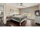 Comfortable bedroom with a ceiling fan, dark wood floors and access to the backyard through a window at 2975 E Tulsa St, Gilbert, AZ 85295