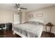 Cozy bedroom featuring a white bed frame, soft gray bedding, and a quaint corner desk at 2975 E Tulsa St, Gilbert, AZ 85295