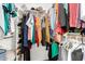 Well-organized walk-in closet with shelving, clothing rods, and a variety of apparel and accessories at 2975 E Tulsa St, Gilbert, AZ 85295