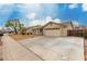 Charming single-level home featuring a tile roof and a well-maintained front yard and a long driveway at 2975 E Tulsa St, Gilbert, AZ 85295