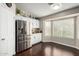 Bright kitchen featuring white cabinets, stainless steel appliances, granite countertops, and large windows at 2975 E Tulsa St, Gilbert, AZ 85295