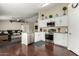 Modern kitchen featuring white cabinets, stainless steel appliances, and granite countertops at 2975 E Tulsa St, Gilbert, AZ 85295