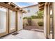 Back patio featuring a concrete pad, gravel and foliage at 3143 N Evergreen St, Buckeye, AZ 85396