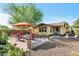 Backyard patio with outdoor seating, mature landscaping, and shade trees for enjoying time outside at 3143 N Evergreen St, Buckeye, AZ 85396