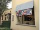 Charming barbershop with a classic barber pole, complemented by lush greenery at 3143 N Evergreen St, Buckeye, AZ 85396