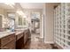 Bathroom featuring dual sinks, marble floors and access to the main bedroom at 3143 N Evergreen St, Buckeye, AZ 85396