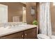 Bathroom featuring a vanity sink with stone countertop and shower with a patterned curtain at 3143 N Evergreen St, Buckeye, AZ 85396