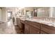 Main bathroom with and sinks, marble tile floors, and vanity seating at 3143 N Evergreen St, Buckeye, AZ 85396