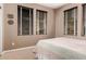 Bedroom featuring three windows providing ample natural light and neutral carpet at 3143 N Evergreen St, Buckeye, AZ 85396