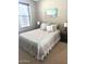 Cozy bedroom with a plush bed, bedside tables with lamps, and a window for natural light at 3143 N Evergreen St, Buckeye, AZ 85396
