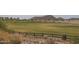 Picturesque golf course with mountain views and a classic wooden fence adding rustic charm at 3143 N Evergreen St, Buckeye, AZ 85396