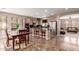 Open-concept kitchen with marble floors, island with seating, and stainless steel appliances at 3143 N Evergreen St, Buckeye, AZ 85396