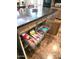 Spacious kitchen island with dark countertops and convenient pull-out wire basket drawers for organized storage at 3143 N Evergreen St, Buckeye, AZ 85396
