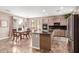 Bright eat-in kitchen features an island, marble tile floors and stainless steel appliances at 3143 N Evergreen St, Buckeye, AZ 85396