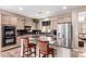 Kitchen features light wood cabinets, marble countertops, and stainless-steel refrigerator at 3143 N Evergreen St, Buckeye, AZ 85396