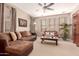 Cozy living room with plush sofas, a ceiling fan, and ample natural light at 3143 N Evergreen St, Buckeye, AZ 85396