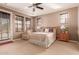 Spacious bedroom featuring a ceiling fan, cozy sitting area, and view to the patio at 3143 N Evergreen St, Buckeye, AZ 85396