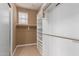 Walk-in closet with shelving, hanging racks, and a window for natural light at 3143 N Evergreen St, Buckeye, AZ 85396