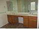 Bathroom featuring a double sink vanity with a large mirror and ample cabinet space at 32020 N 23Rd Ave, Phoenix, AZ 85085