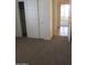 Bedroom showcases closet with sliding doors, and an entrance to another room at 32020 N 23Rd Ave, Phoenix, AZ 85085