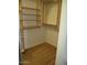 Walk-in closet with built-in shelving and wooden accents for organized storage at 32020 N 23Rd Ave, Phoenix, AZ 85085