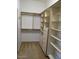 Spacious closet with custom shelving and drawers for ample storage solutions at 32020 N 23Rd Ave, Phoenix, AZ 85085