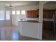 Spacious kitchen featuring a breakfast bar with wooden cabinets and tile flooring at 32020 N 23Rd Ave, Phoenix, AZ 85085