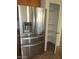 Stainless steel refrigerator and a walk in pantry providing efficient storage solutions at 32020 N 23Rd Ave, Phoenix, AZ 85085