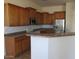 Kitchen featuring wood cabinets, tile floors, stainless steel appliances, and lots of counterspace at 32020 N 23Rd Ave, Phoenix, AZ 85085