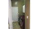 A laundry room with a washer and dryer featuring a door leading to a room at 32020 N 23Rd Ave, Phoenix, AZ 85085