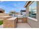 Outdoor kitchen features a built-in grill, counter space, and storage for outdoor cooking and dining at 3309 S 173Rd Ln, Goodyear, AZ 85338