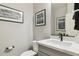 Compact powder room with framed wall art, a toilet, and a vessel sink at 3309 S 173Rd Ln, Goodyear, AZ 85338