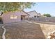 A view of the home's backyard featuring a covered patio and mature trees at 41176 N Cambria Dr, San Tan Valley, AZ 85140