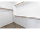Walk-in closet with carpeting and wooden hanging rods for optimal storage at 41176 N Cambria Dr, San Tan Valley, AZ 85140