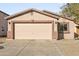 Charming single-story home featuring a two-car garage, desert landscaping, and a welcoming facade at 41176 N Cambria Dr, San Tan Valley, AZ 85140