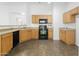 Functional kitchen featuring tile floors, ample counter space, and black appliances that complement the decor at 41176 N Cambria Dr, San Tan Valley, AZ 85140