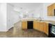 Open-concept kitchen offering lots of counter space, an undermount sink, and easy access to the living area at 41176 N Cambria Dr, San Tan Valley, AZ 85140