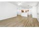 Open living space with wood-look flooring, seamlessly connecting to the kitchen and dining areas at 41176 N Cambria Dr, San Tan Valley, AZ 85140