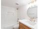 Well-lit bathroom features stylish tiles in the shower, and a vanity with a modern, round mirror at 4201 E Camelback Rd # 28, Phoenix, AZ 85018