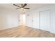 Spacious bedroom with light floors, white walls, ceiling fan, and convenient closet space at 4201 E Camelback Rd # 28, Phoenix, AZ 85018