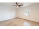 Bright bedroom featuring light wood-style floors, large windows, and a modern ceiling fan at 4201 E Camelback Rd # 28, Phoenix, AZ 85018