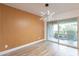 Dining room with wood accent wall and sliding doors to patio at 4201 E Camelback Rd # 28, Phoenix, AZ 85018