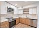 Modern kitchen with stainless steel appliances, white cabinets, and quartz countertops at 4201 E Camelback Rd # 28, Phoenix, AZ 85018