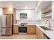 Bright kitchen features updated appliances and a combination of white and wood cabinetry at 4201 E Camelback Rd # 28, Phoenix, AZ 85018