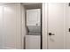A convenient laundry area features a stacked washer and dryer unit nestled between two white doors at 4201 E Camelback Rd # 28, Phoenix, AZ 85018