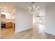 Open floor plan with kitchen, living room, and decorative hanging light fixture at 4201 E Camelback Rd # 28, Phoenix, AZ 85018