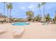 Large community pool featuring lounge chairs, shade structures and well-maintained landscaping at 4201 E Camelback Rd # 28, Phoenix, AZ 85018
